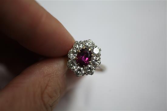 An 18ct white gold, ruby and diamond cluster ring, size N.